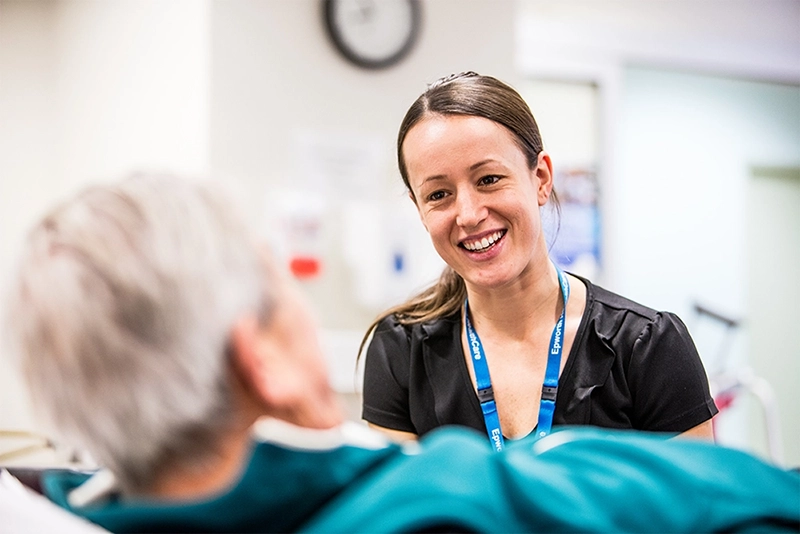 nurse smiling at a patient 